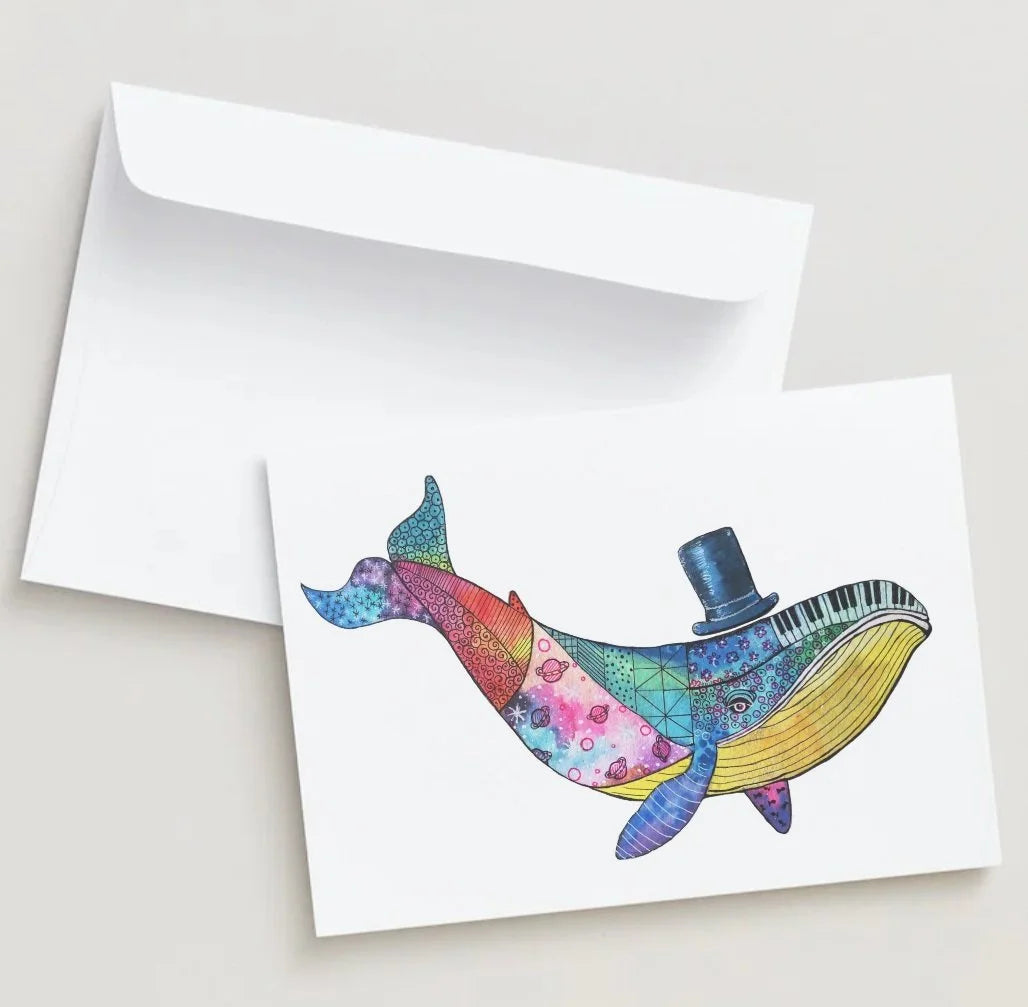 Colorful whale illustration on a card with a white envelope.