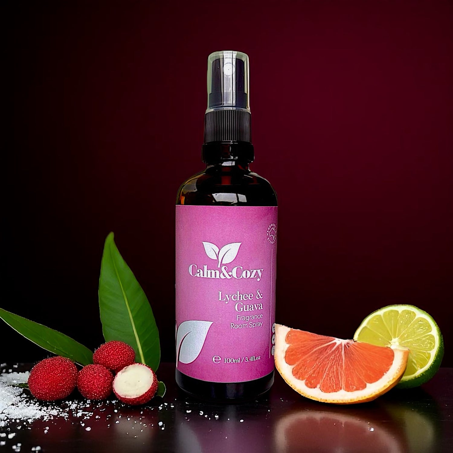 Bottle of Calm & Cozy spray with lychee and guava on a dark background