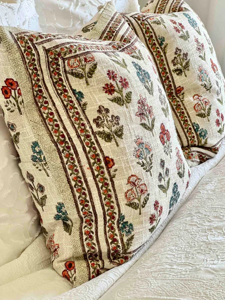 Decorative pillow with floral patterns on a neutral background