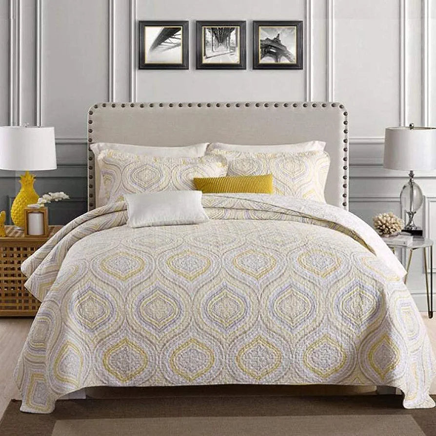 Bedroom with a bed featuring a patterned comforter and pillows, flanked by lamps and decorative items.