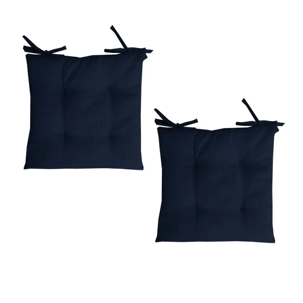 Two navy blue outdoor polyester solid chair pads with corner ties for added comfort