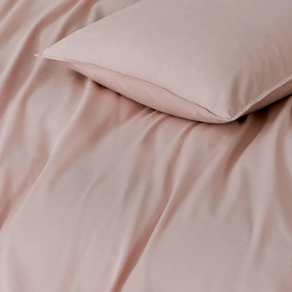 Soft pink pillow on matching bedding showcasing Vintage Washed Standard Pillowcases