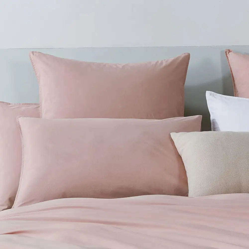 Soft pink Vintage Washed Standard Pillowcases with envelope closure elegantly arranged on a bed