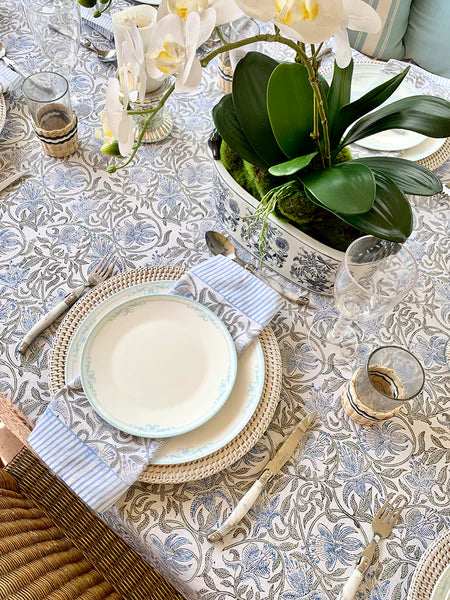 Elegant table setting with floral centerpiece on a patterned tablecloth
