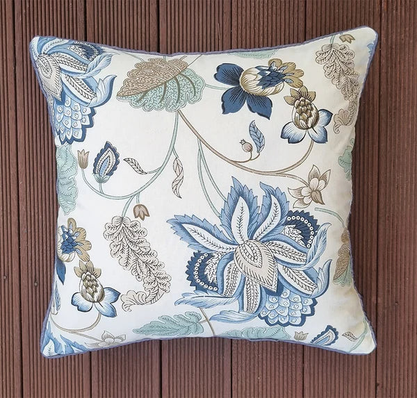Decorative pillow with floral pattern on a wooden surface
