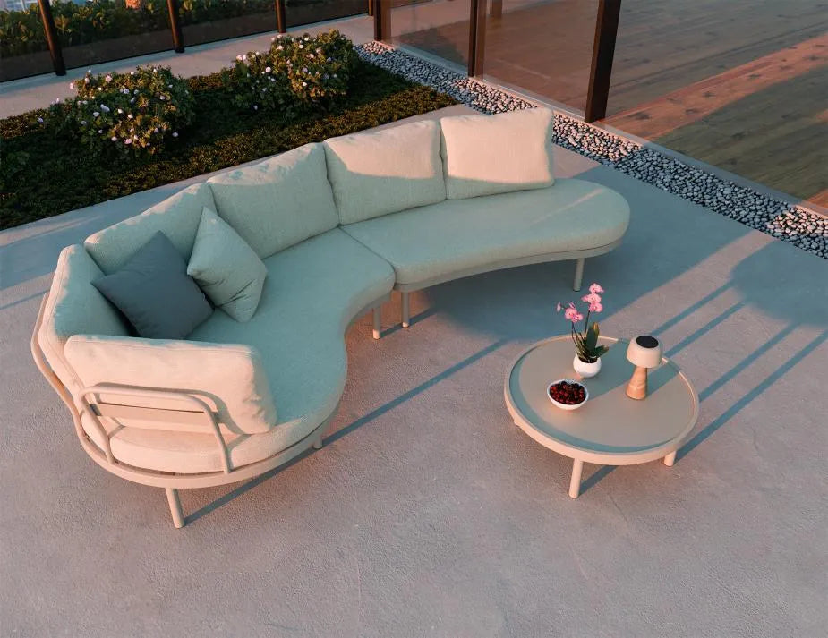 Modern outdoor sofa set with a small round table on a patio