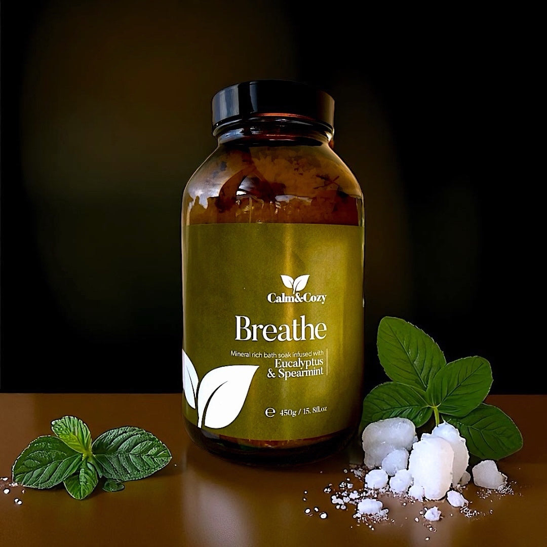 Bottle of 'Breathe' supplement with mint leaves and Himalayan salt on a dark background