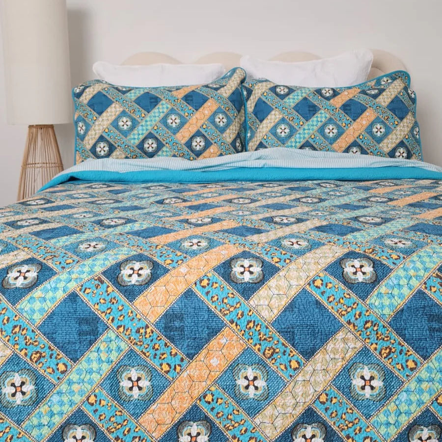 Quilt with geometric pattern on a bed in a bedroom setting