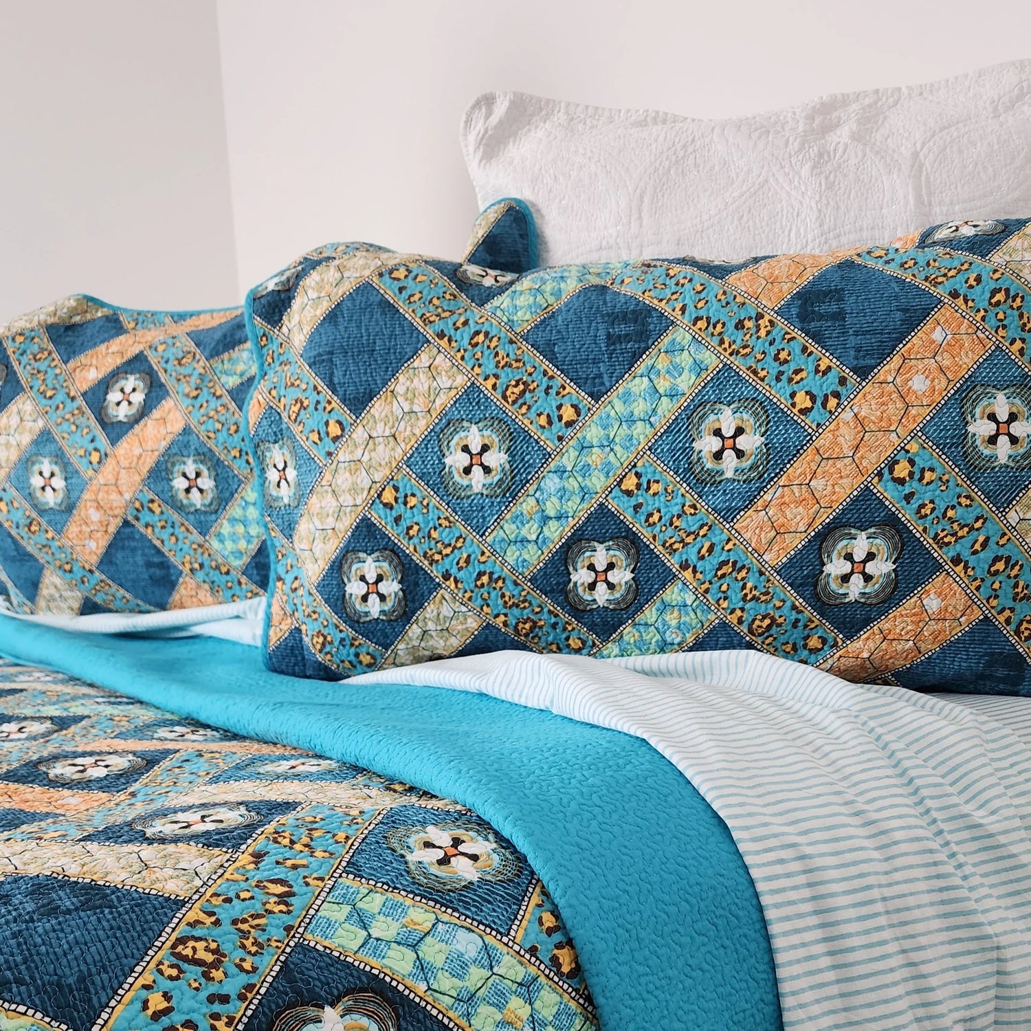 Decorative quilt with geometric pattern on a bed