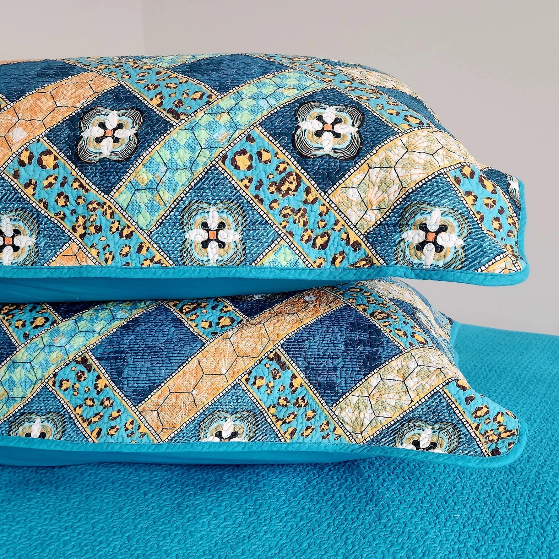 Decorative pillows with a blue and orange pattern on a gray background