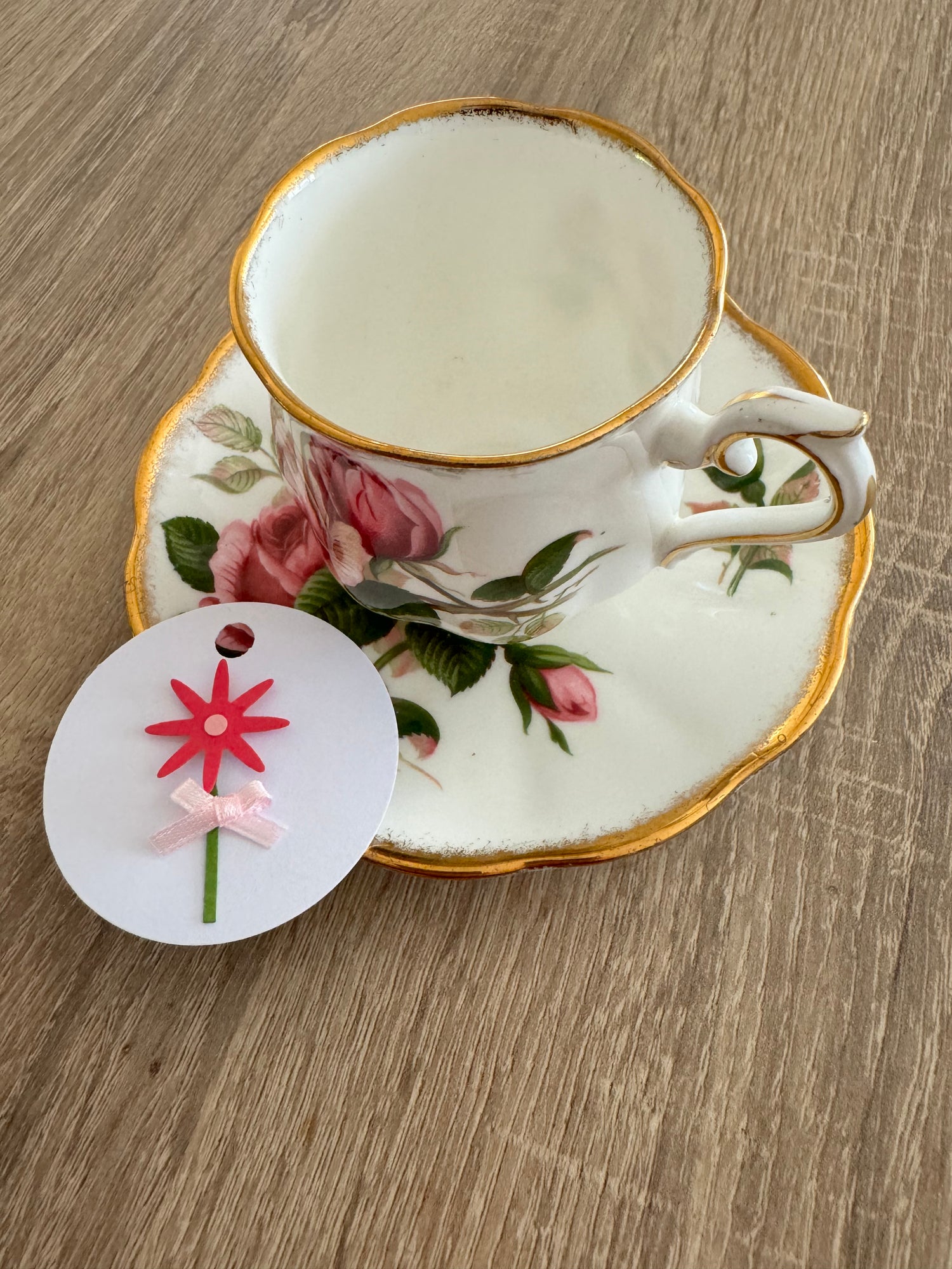 Decorative teacup with floral design on a wooden surface