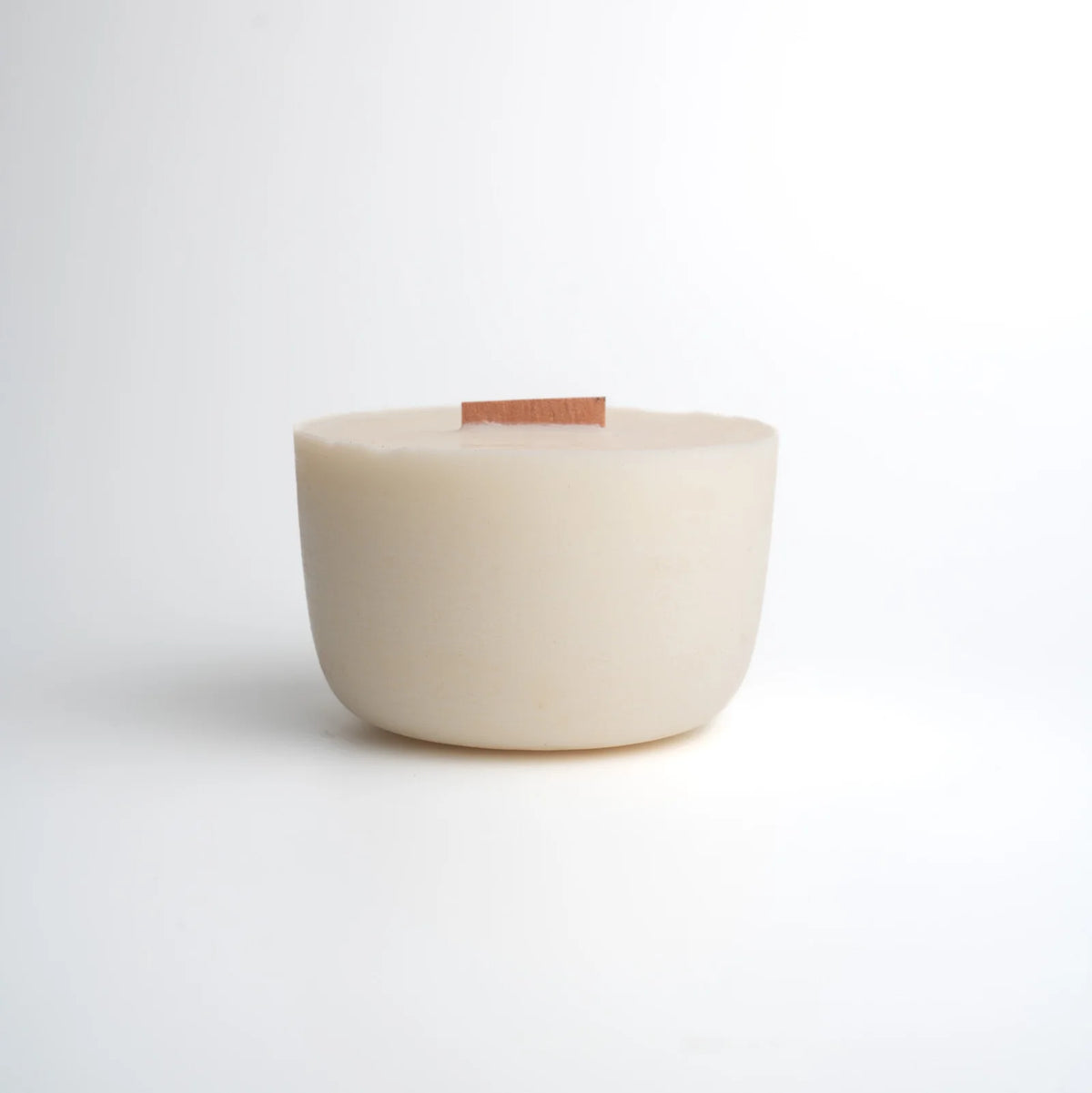 White ceramic bowl with a wooden base on a light gray background
