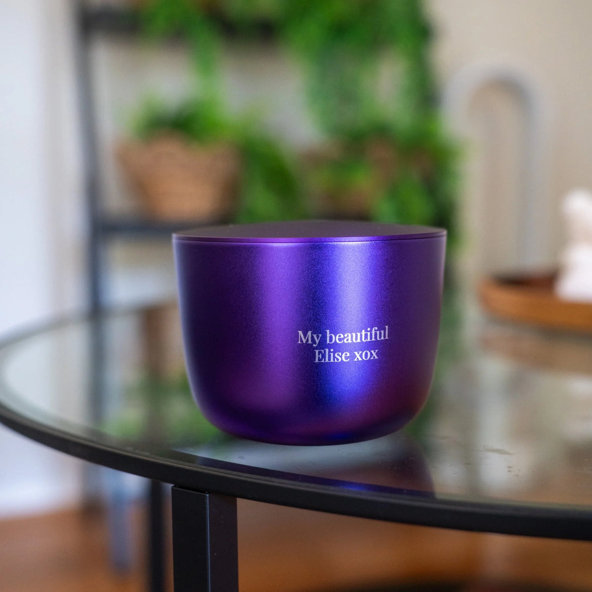 Purple bowl with 'My beautiful Elise xox' text on a glass table