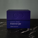 Blue box labeled 'Forever Jar' on a dark surface with a gray background