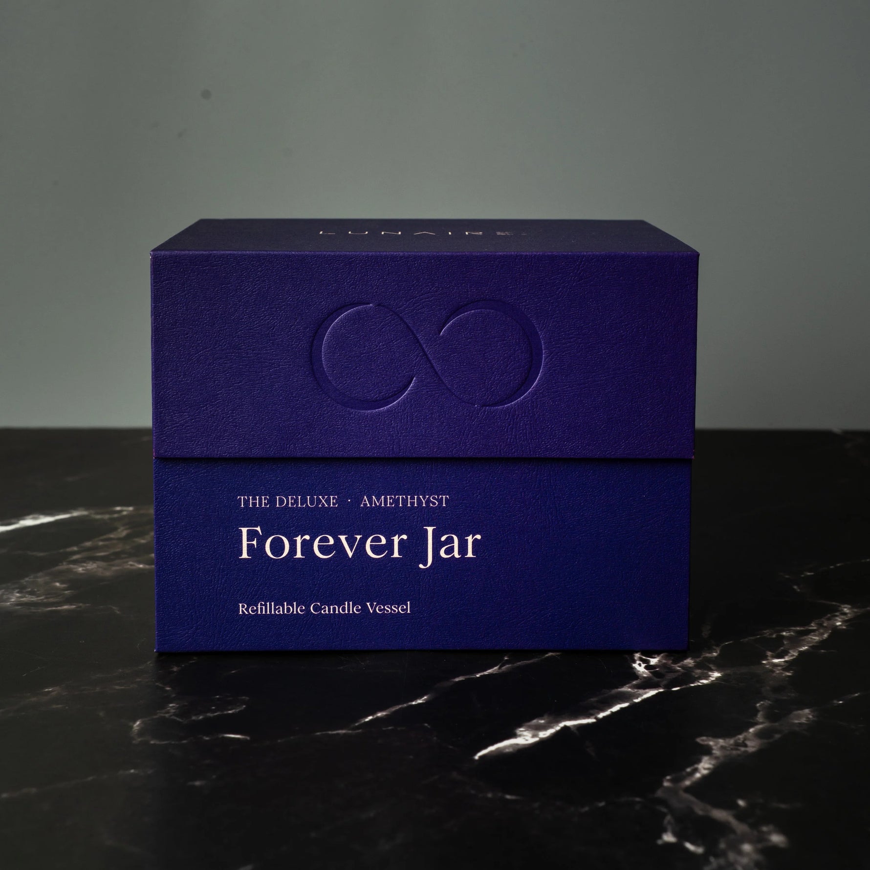 Blue box labeled 'Forever Jar' on a dark surface with a gray background