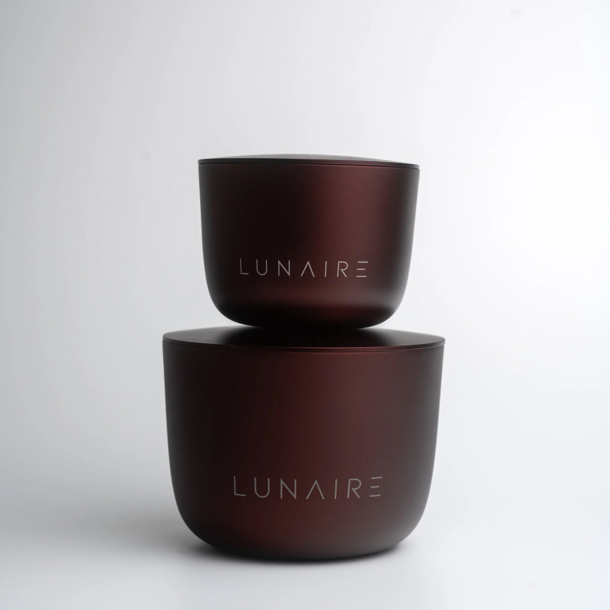 Two brown ceramic bowls stacked on a white background with 'LUNAIRE' branding.