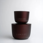 Two brown ceramic bowls stacked on a white background with 'LUNAIRE' branding.