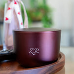 Purple container with 'ZR' logo on a wooden surface