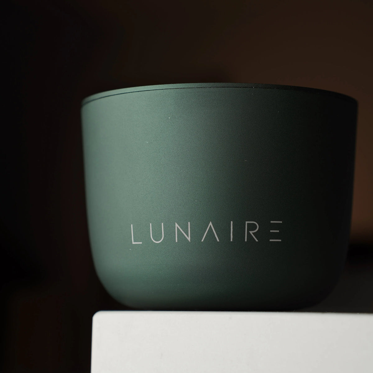 Green container with 'LUNAIRE' branding on a dark background