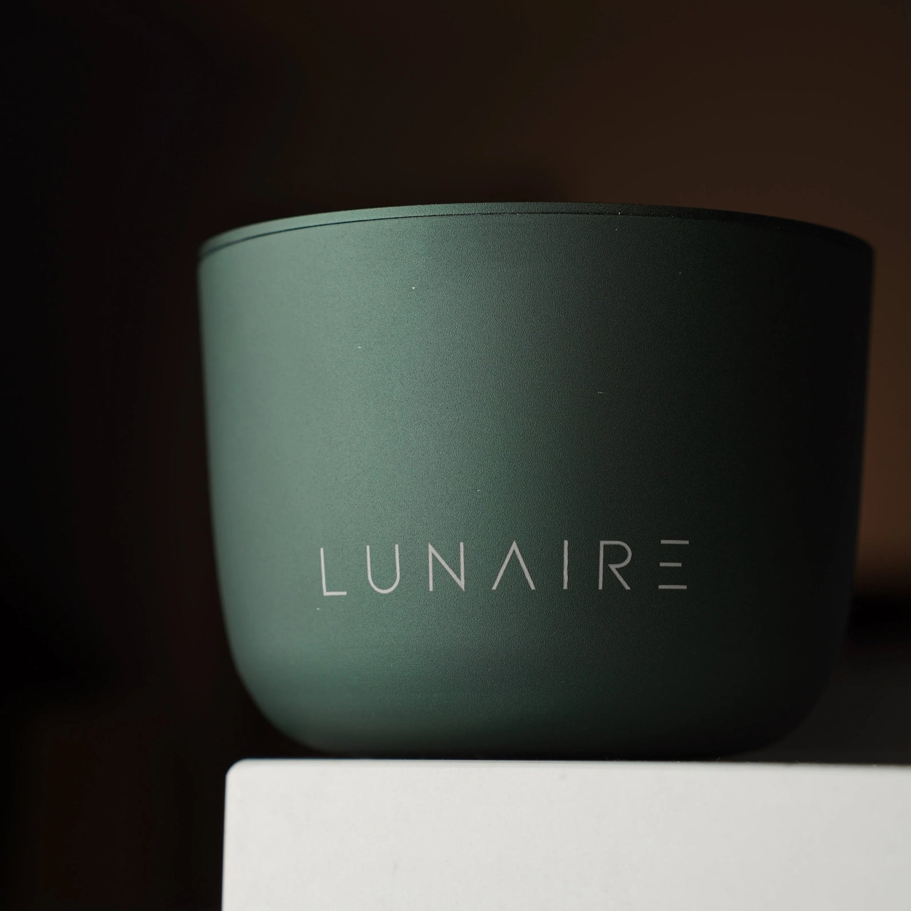 Green container with 'LUNAIRE' branding on a dark background