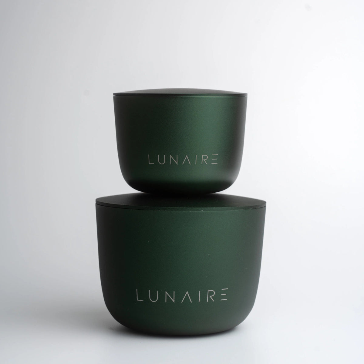 Two green containers with 'LUNAIRE' branding on a white background