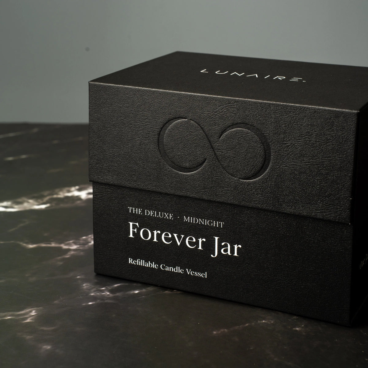 Black box with 'LUNAIRE' branding and 'Forever Jar' text on a dark surface.
