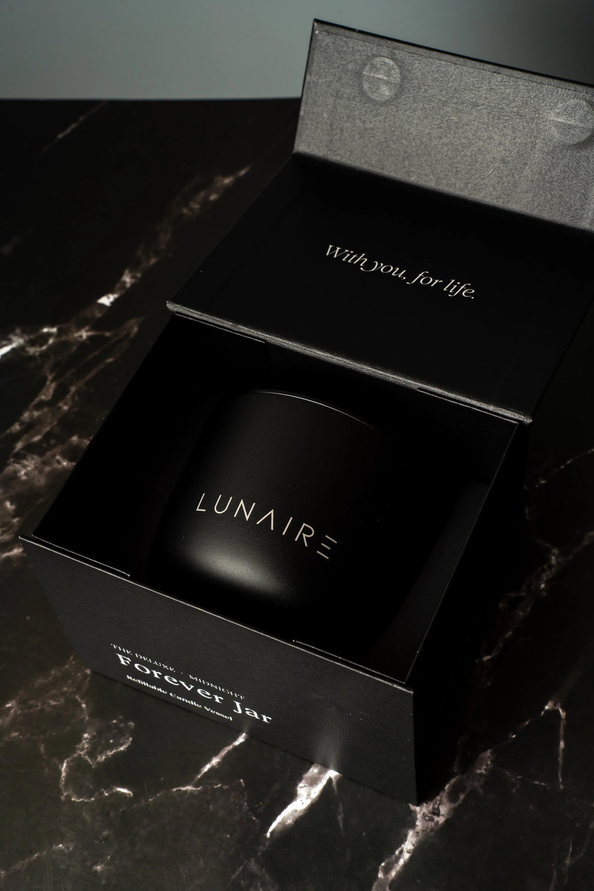 Black box with 'LUNAIRE' branding on a marble surface