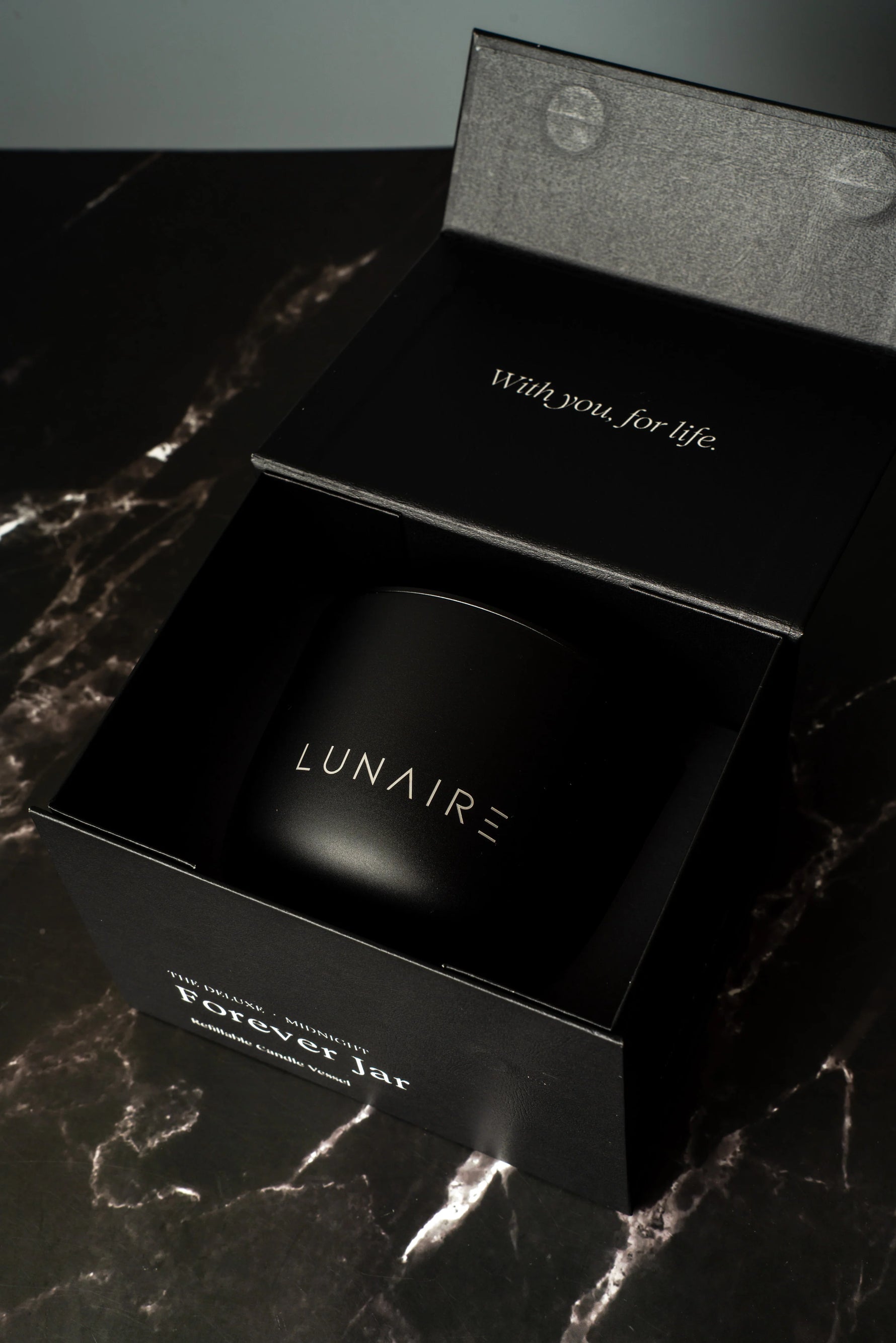Black box with 'LUNAIRE' branding on a marble surface