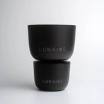 Two black containers with 'LUNAIRE' branding on a light gray background