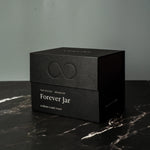 Black box with 'Forever Jar' text on a dark surface
