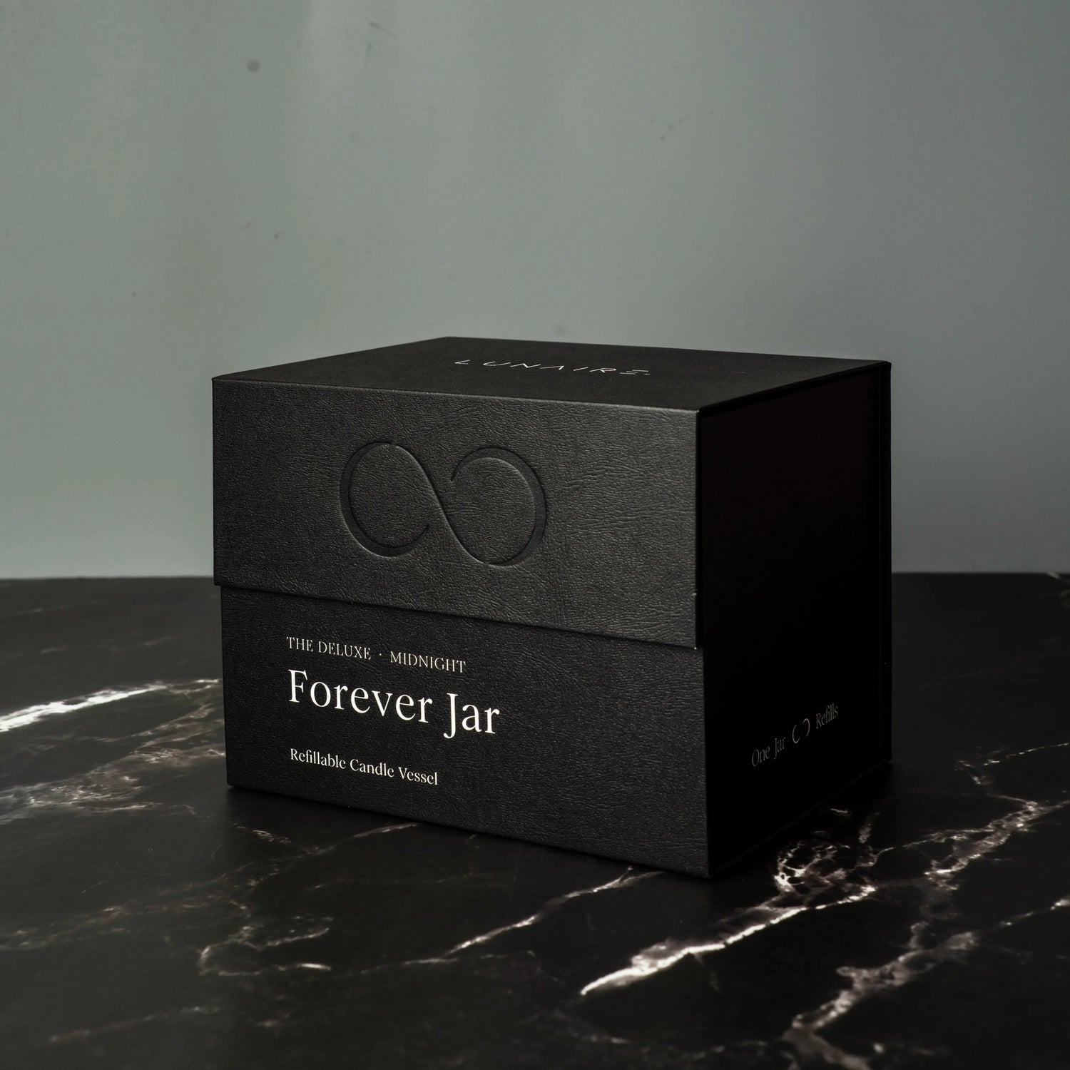 Black box with 'Forever Jar' text on a dark surface