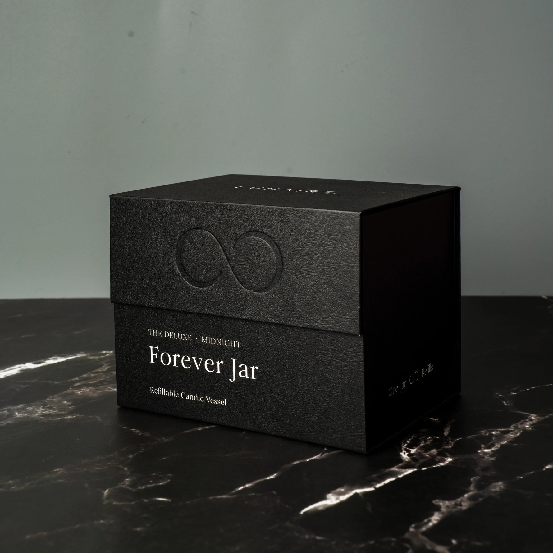 Black box with 'Forever Jar' text on a dark surface