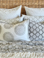 Decorative pillows with intricate patterns on a textured surface