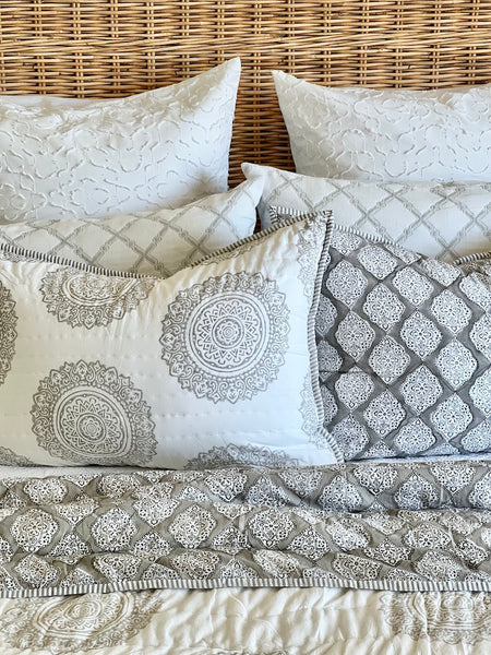 Decorative pillows with intricate patterns on a textured surface