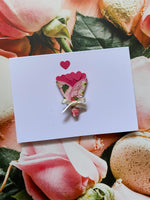 Card with floral design on a floral background