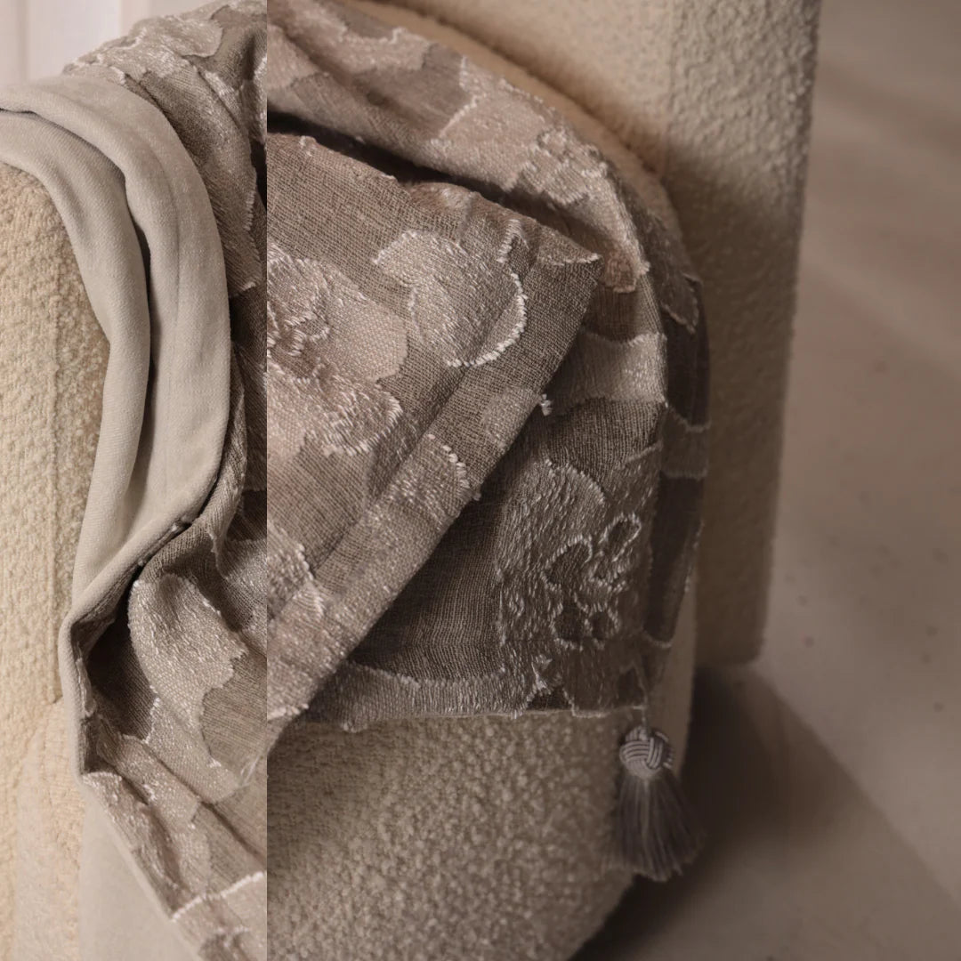 Textured fabric with floral pattern draped over a neutral background