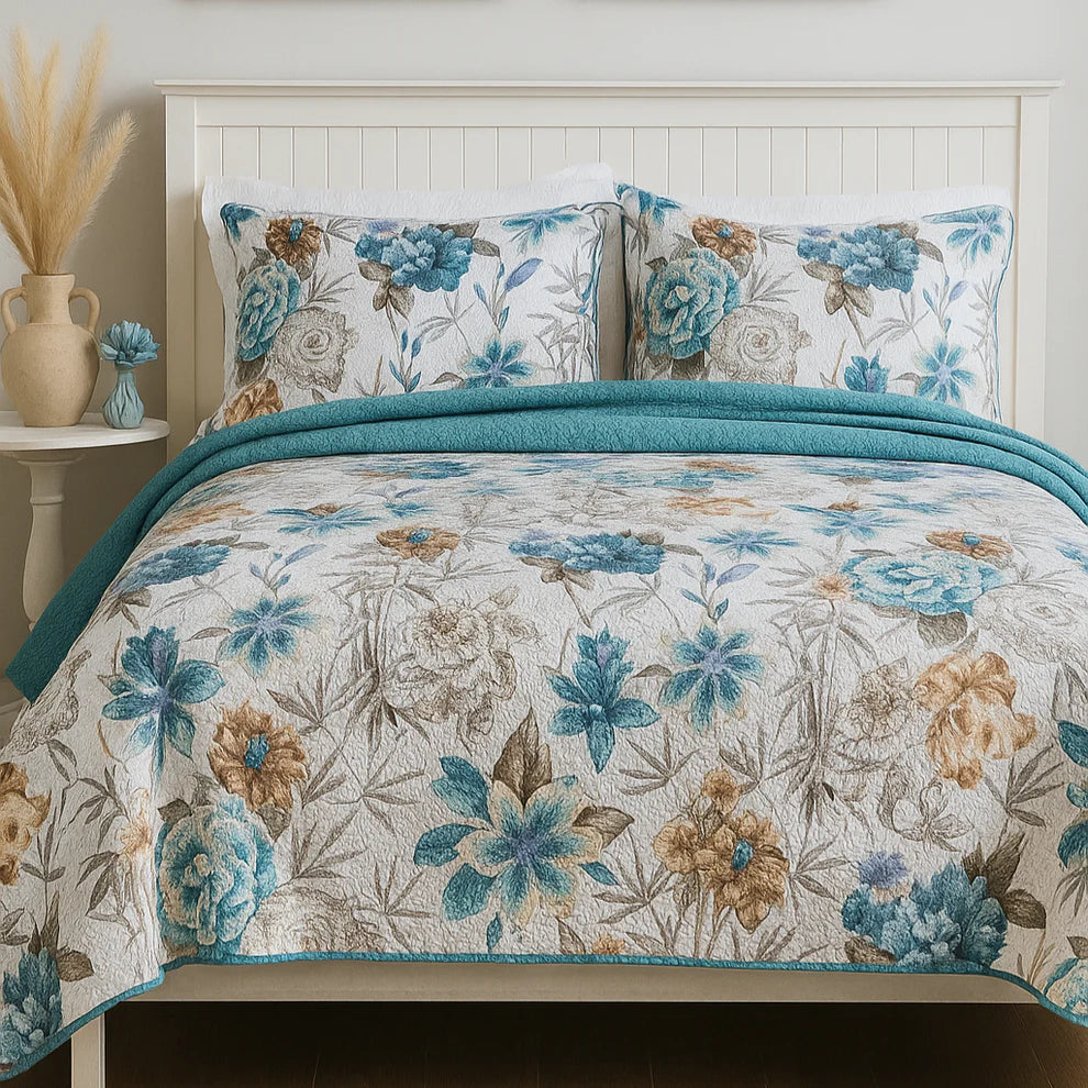 Floral patterned quilt and pillows on a bed with a side table.