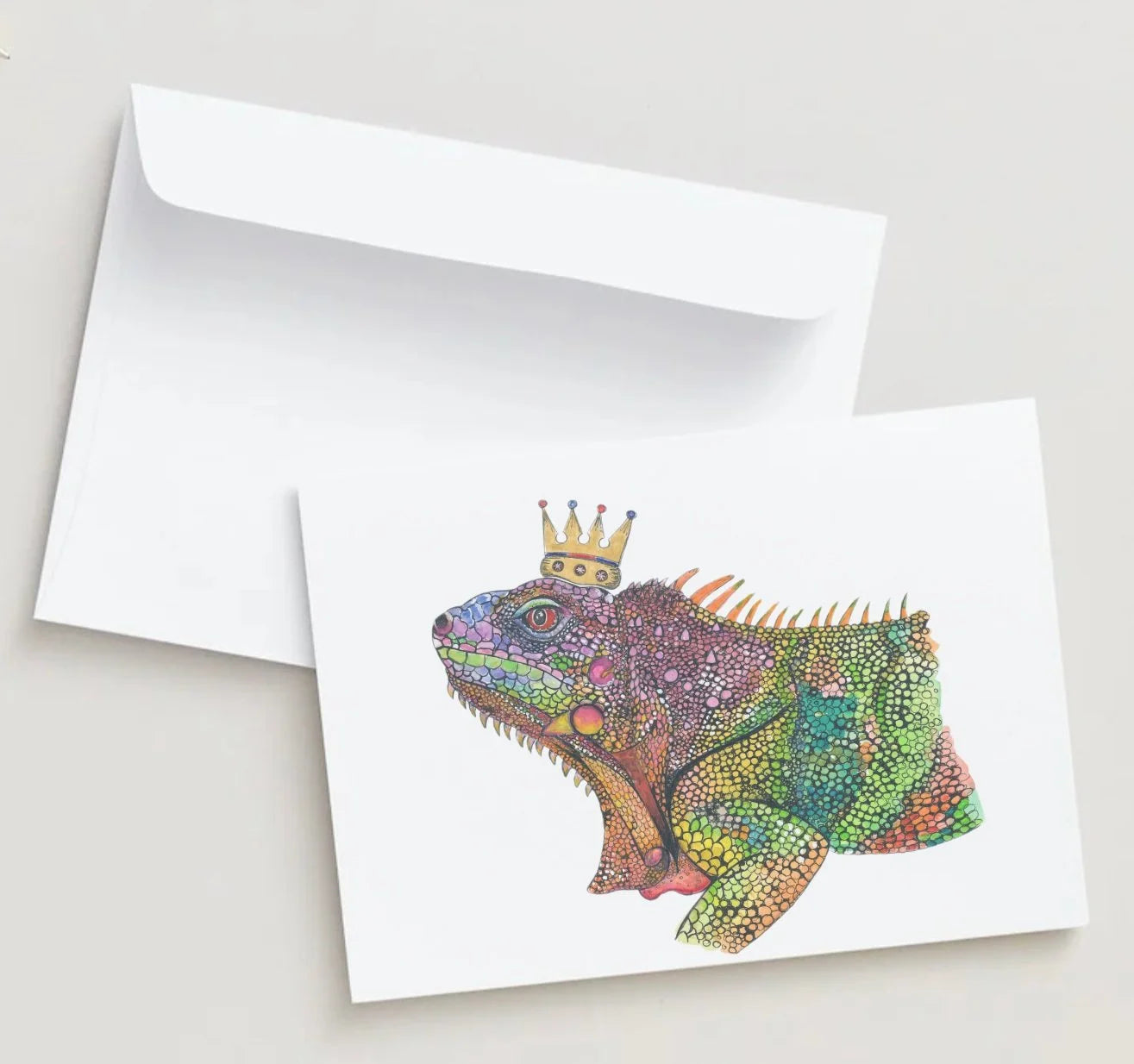 Colorful lizard illustration with a crown on a white card with an envelope.