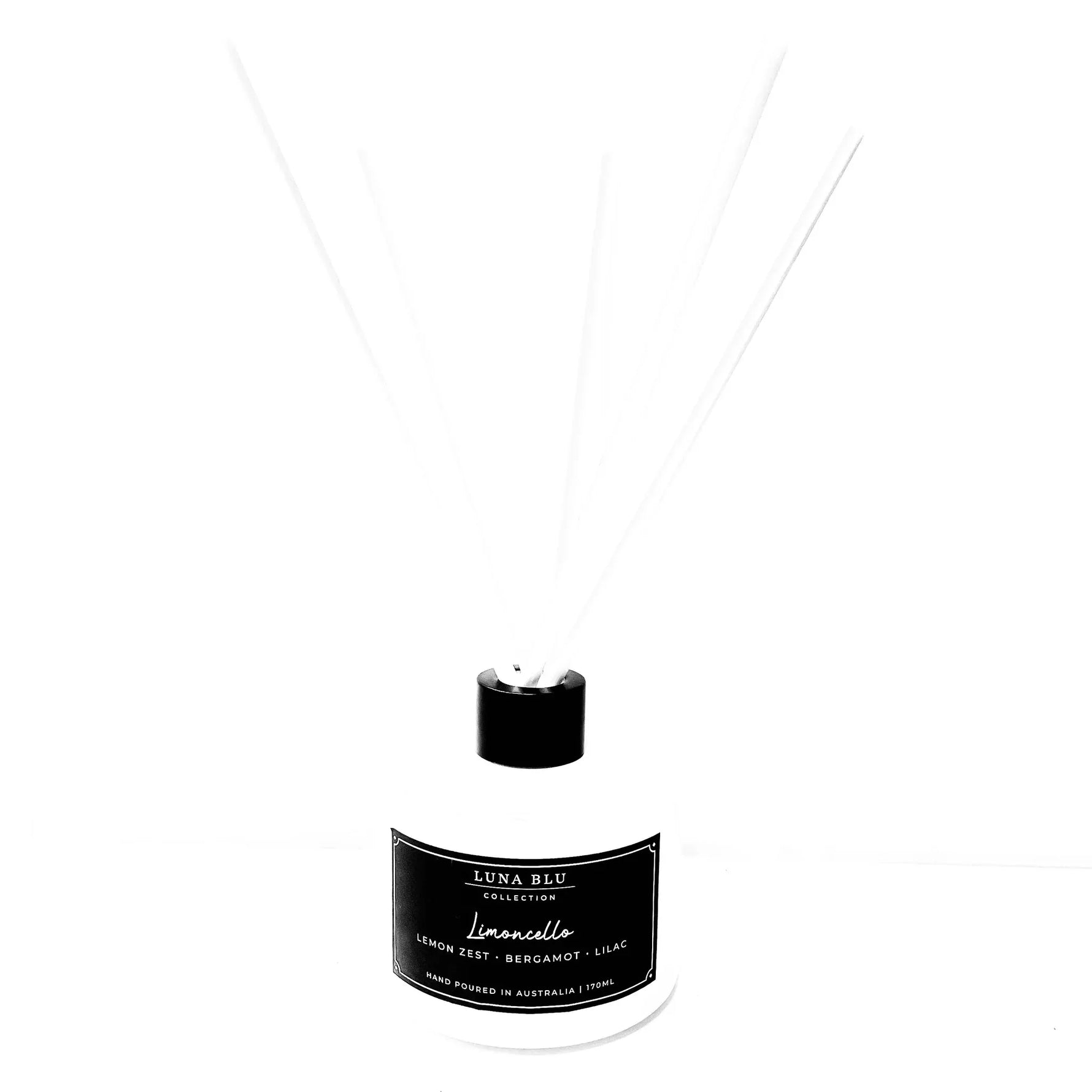 A reed diffuser bottle with a black cap and a black label reading 'Luna Blue Collection' and 'Lumencello', with several thin white reeds extending upward against a white background.