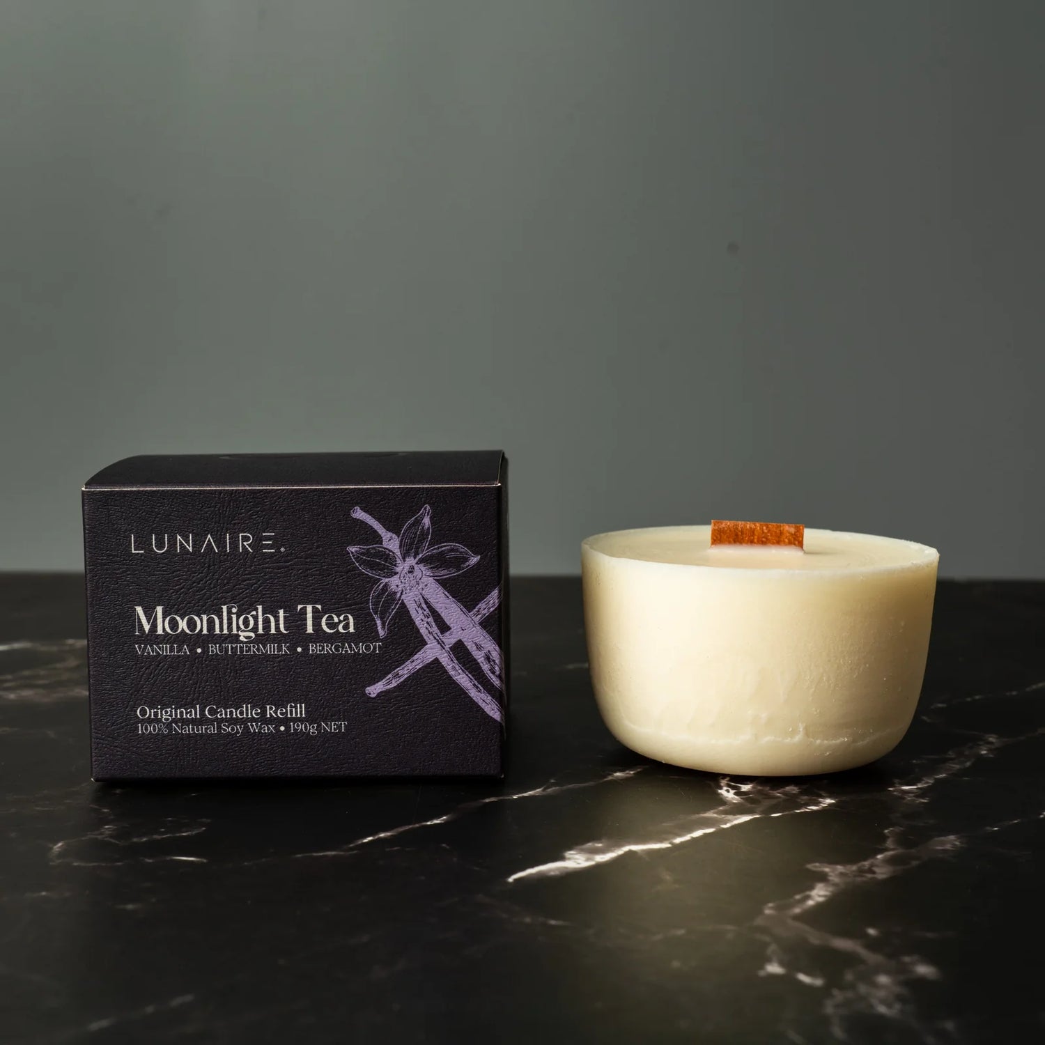 Lunaire Moonlight Tea candle refill box and candle on a dark surface