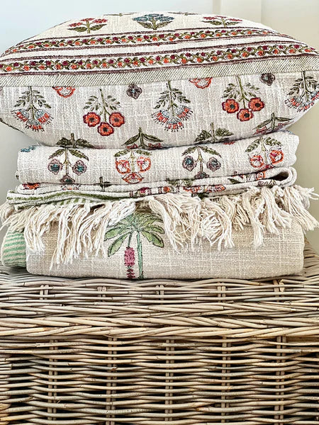 Stack of patterned towels on a wicker basket