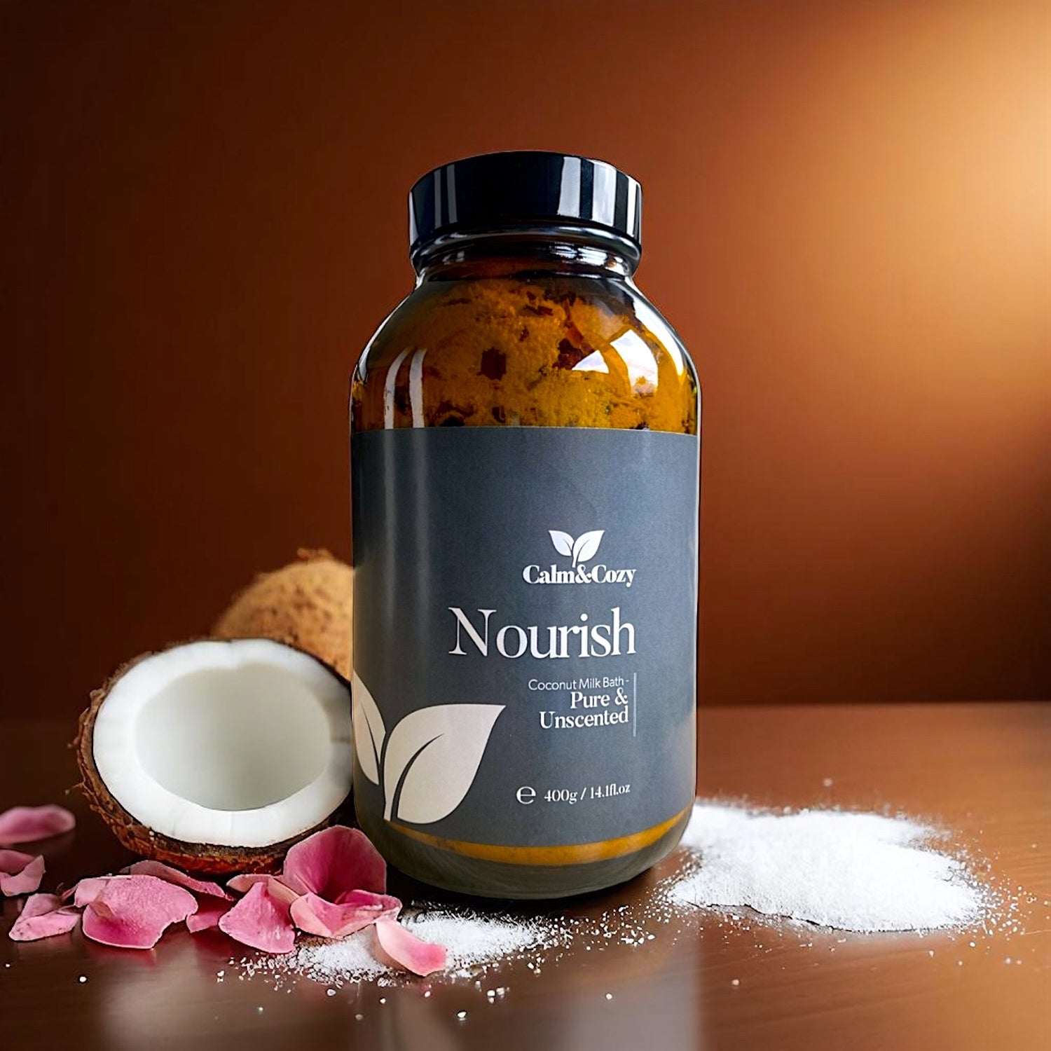 Bottle of 'Nourish' product with coconut and rose petals on a wooden surface