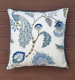 Decorative pillow with floral pattern on a wooden surface