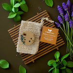 Natural soap on a wooden soap dish with lavender and green leaves on a brown background