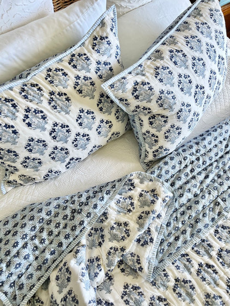 Floral-patterned quilt and pillows on a sofa