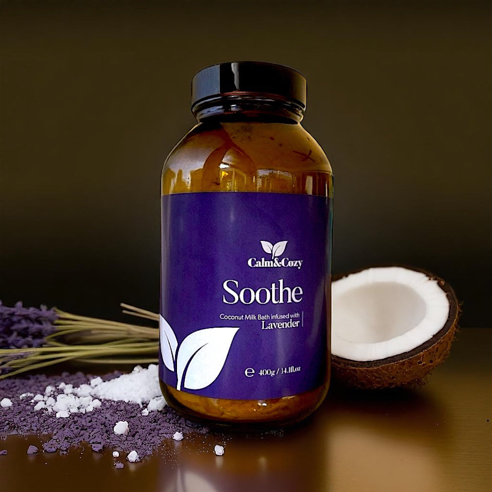 Bottle of 'Calm & Cozy Soothe' product with lavender and coconut on a dark background
