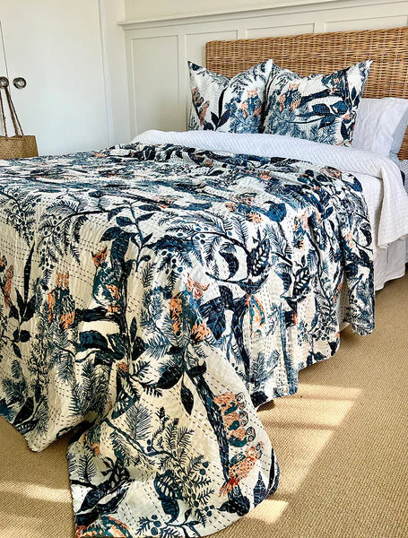 Floral patterned comforter set on a bed in a bedroom.