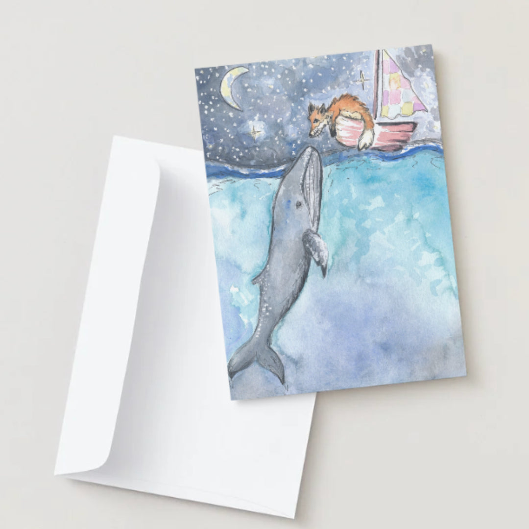 Greeting card with a whale and sailboat design on a white background