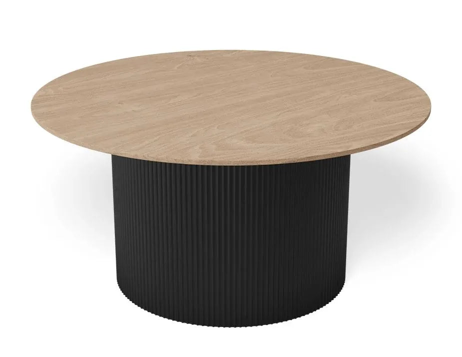 A round coffee table with a light oak wood-grain top and a black ribbed cylindrical pedestal base, shown on a clean white background.