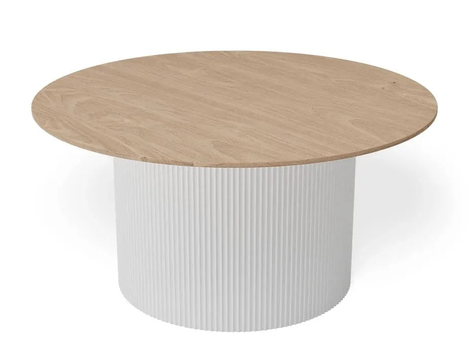 A round dining table with a light oak wood-grain top and a white fluted cylindrical pedestal base, shown on a clean white background.